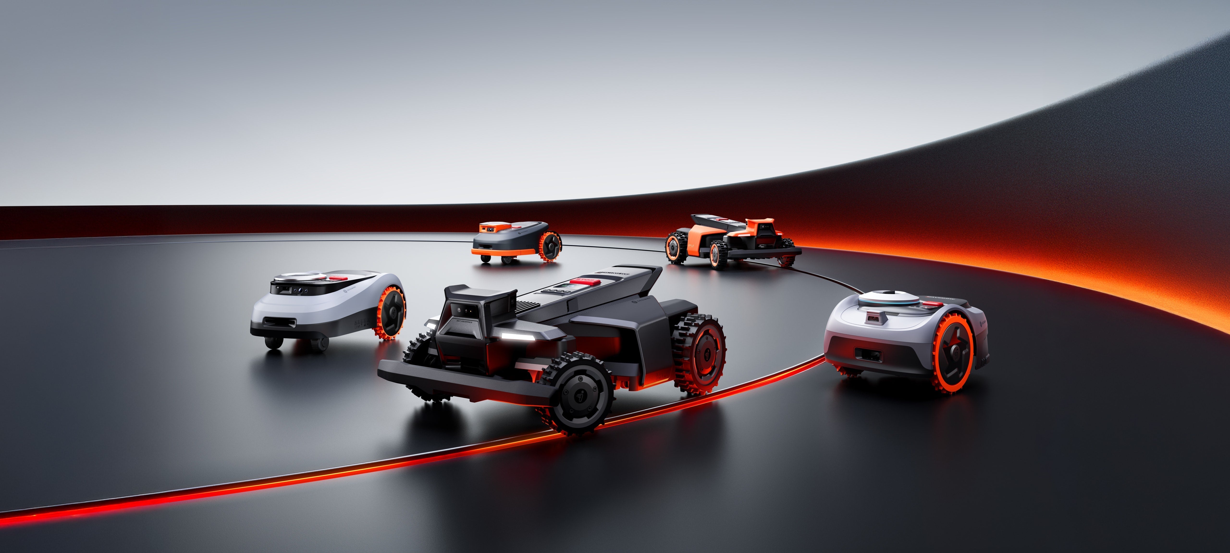 Segway Navimow robot lawn mowers on modern black and orange track