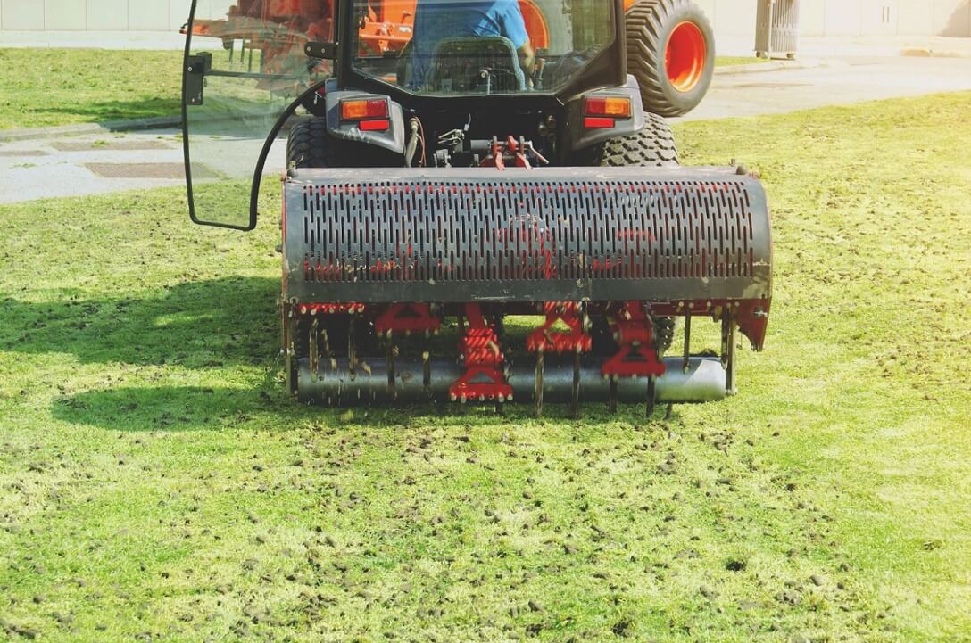 Segway Navimow robot mower aerates lawn on green grass