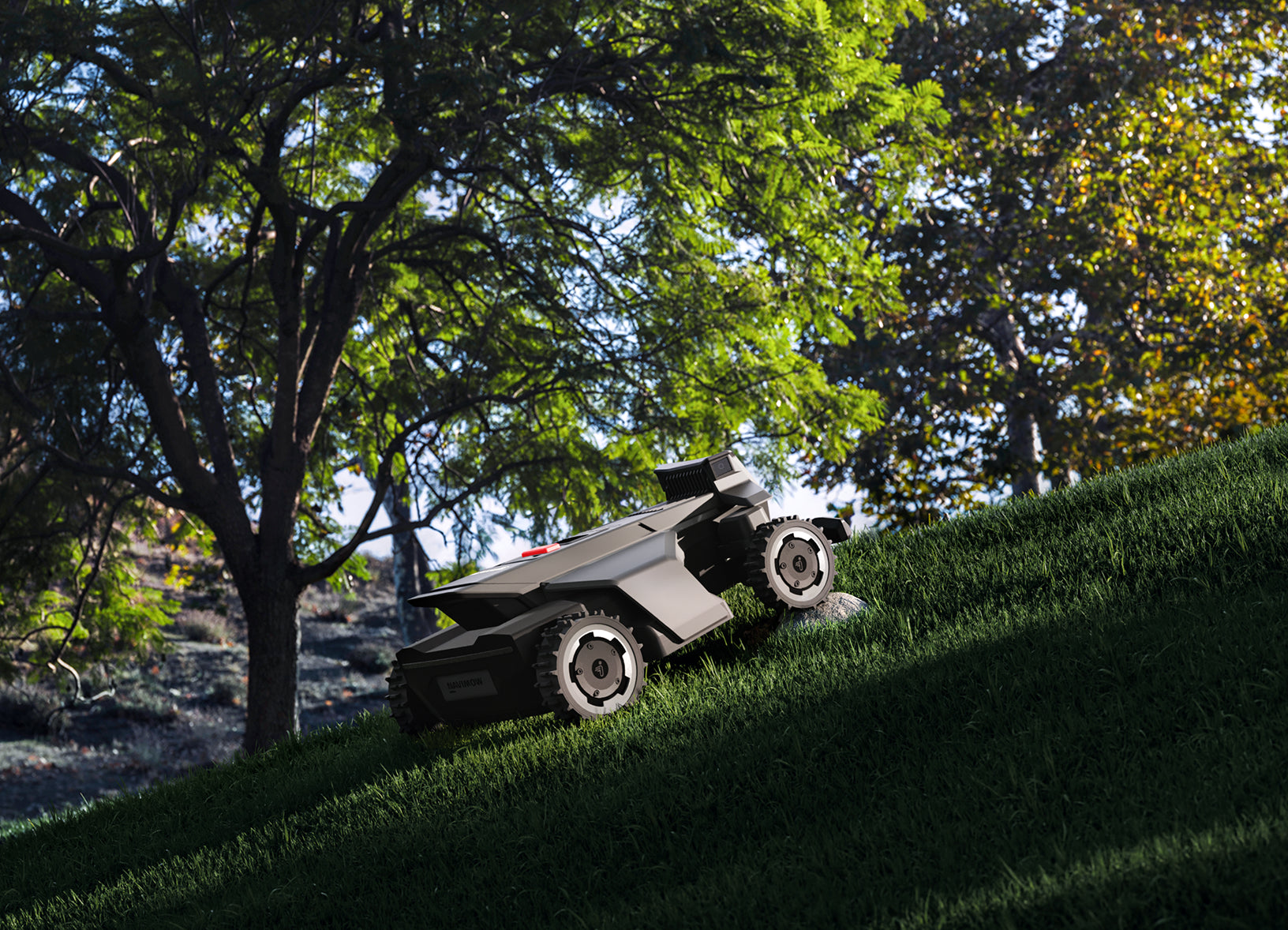Navimow i110E robot lawn mower climbing up a steep hill.