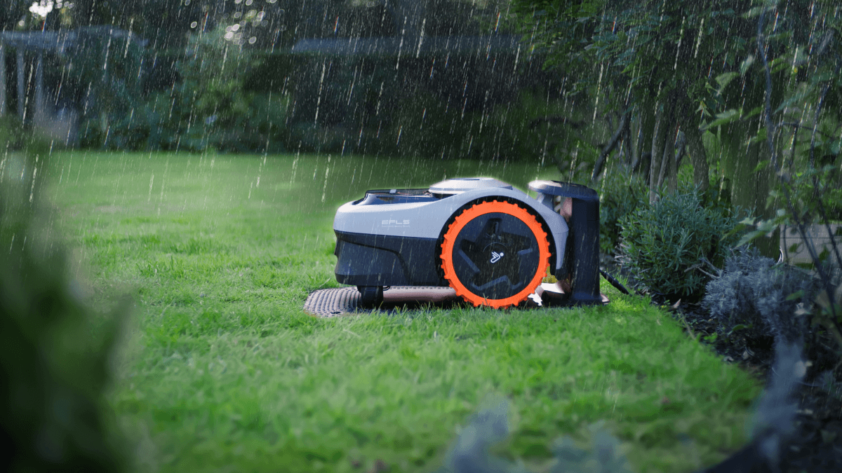 Segway Navimow robot lawn mower operating in rain on grass