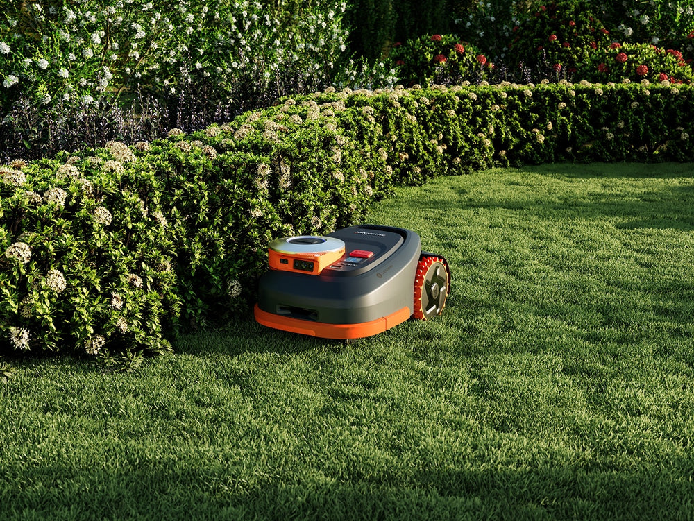 A Segway Navimow H2 robot lawn mower on green grass.