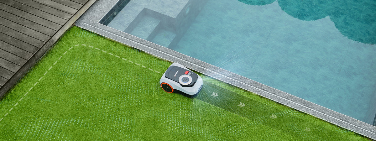 Navimow i2 LiDAR robot lawn mower trims grass near the pool.