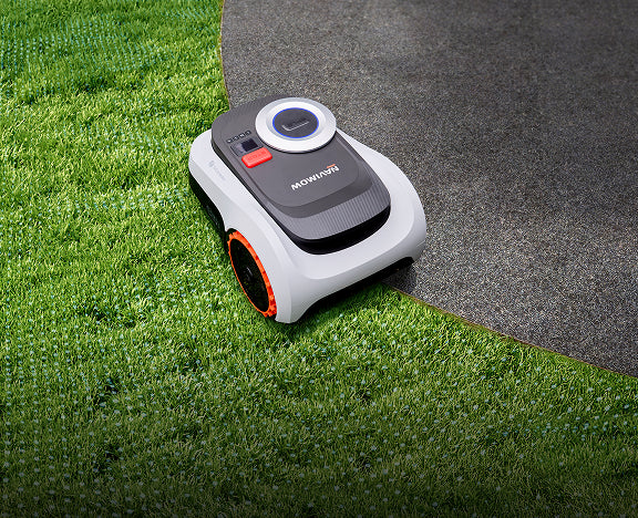 The Navimow i2 LiDAR robot lawn mower mows the green grass.